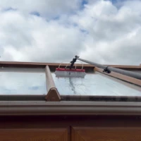 Home Water-fed pole cleaning conservatory roof windows at a home in Bush Hill.